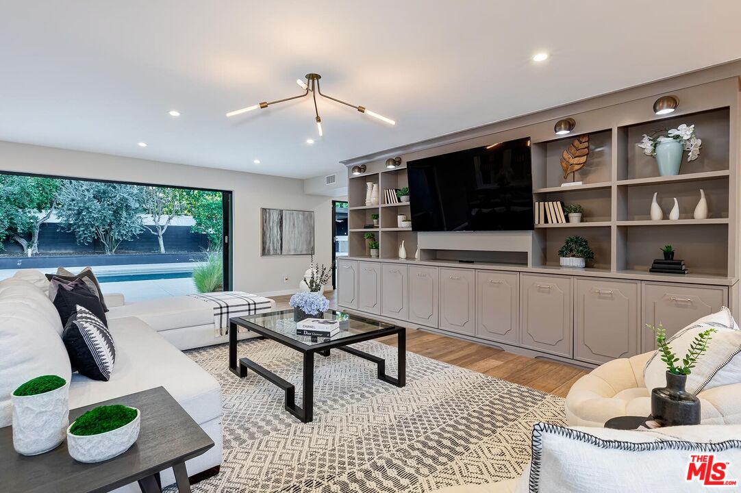 5401 Ostrom Avenue Encino, CA 91316 - Photo 1 of 73 a living room with furniture and a flat screen tv