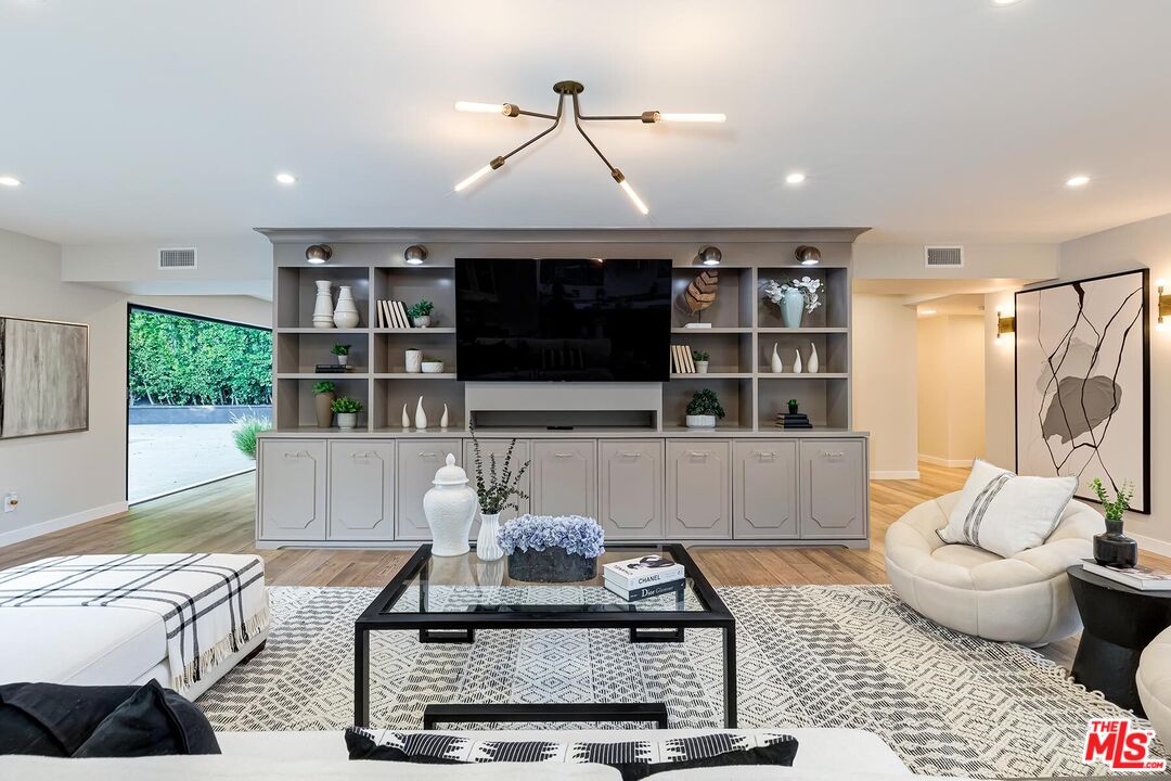 5401 Ostrom Avenue Encino, CA 91316 - Photo 12 of 73 a living room with furniture and a flat screen tv