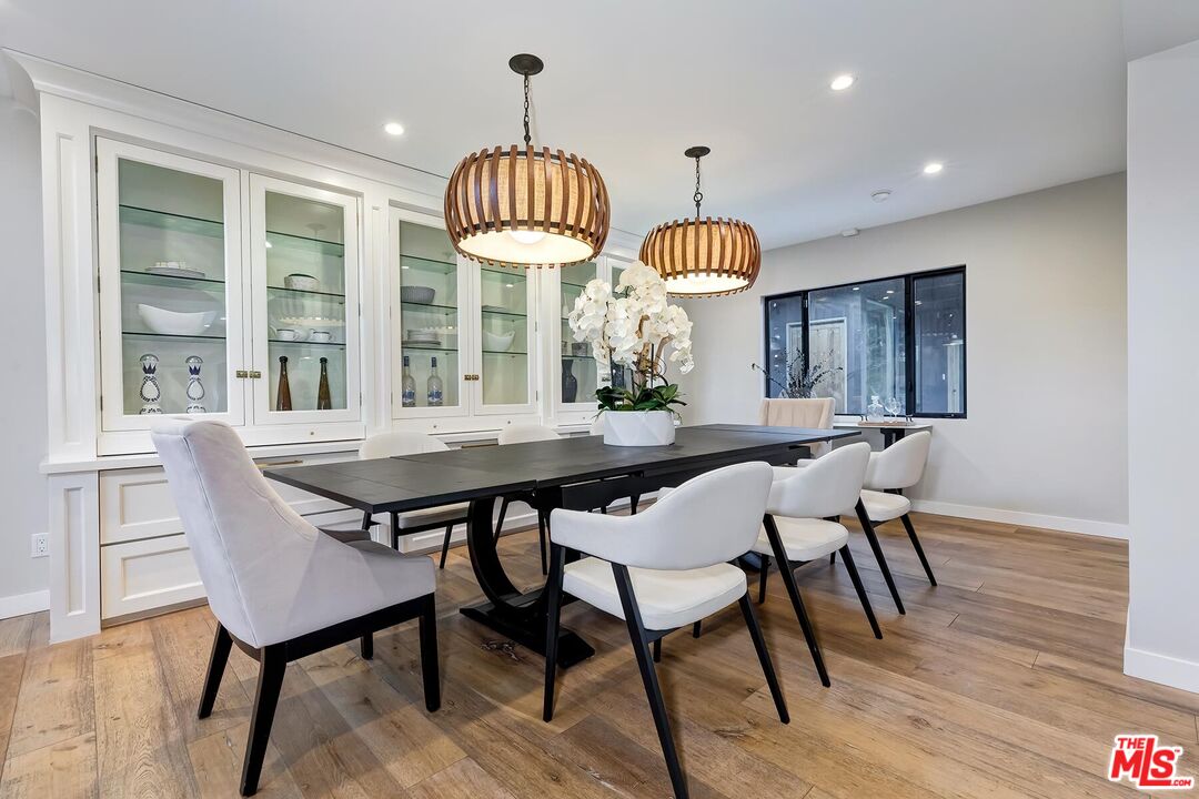 5401 Ostrom Avenue Encino, CA 91316 - Photo 19 of 73 a view of a dining room with furniture window and wooden floor