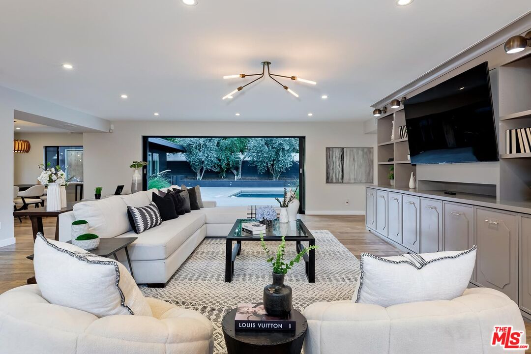 5401 Ostrom Avenue Encino, CA 91316 - Photo 2 of 73 a living room with furniture and a flat screen tv