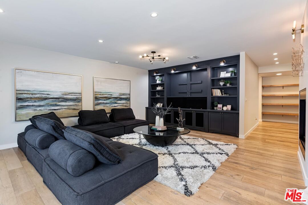 5401 Ostrom Avenue Encino, CA 91316 - Photo 24 of 73 a living room with furniture and a fireplace