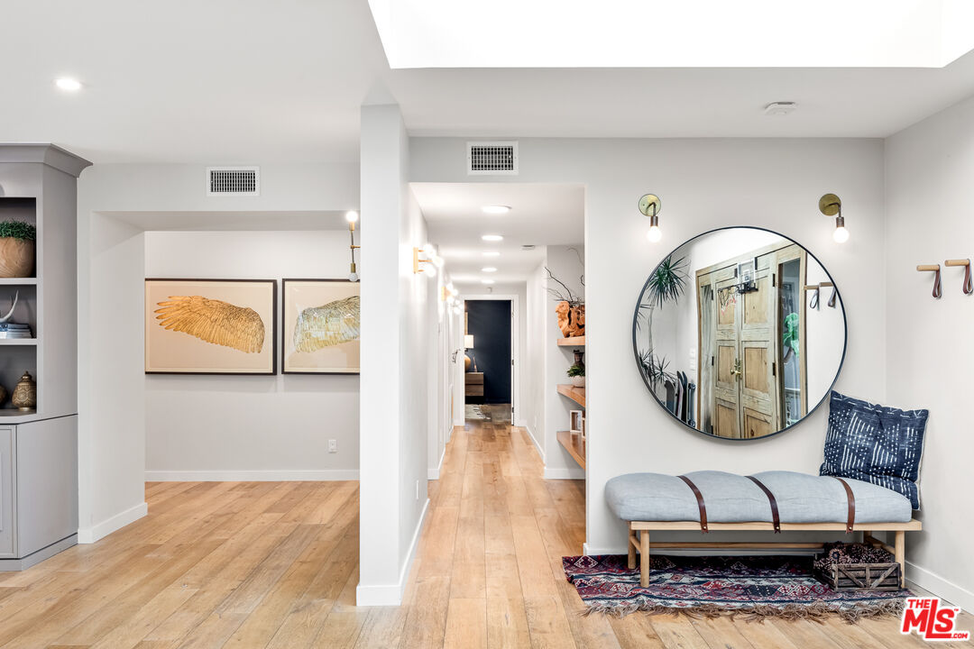 5401 Ostrom Avenue Encino, CA 91316 - Photo 27 of 73 a view of a hallway with wooden floor and entryway