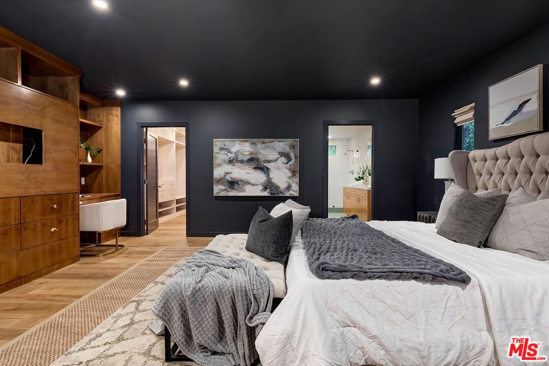 5401 Ostrom Avenue Encino, CA 91316 - Photo 29 of 73 a bedroom with a bed and a flat screen tv
