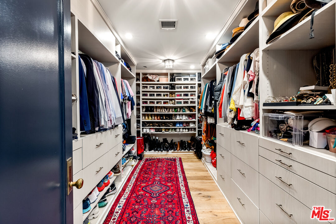 5401 Ostrom Avenue Encino, CA 91316 - Photo 31 of 73 a view of walk in closet with clothes