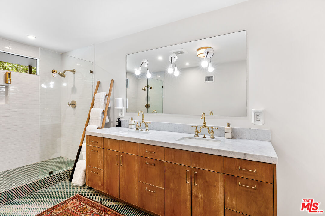 5401 Ostrom Avenue Encino, CA 91316 - Photo 35 of 73 a bathroom with a sink a vanity and a mirror