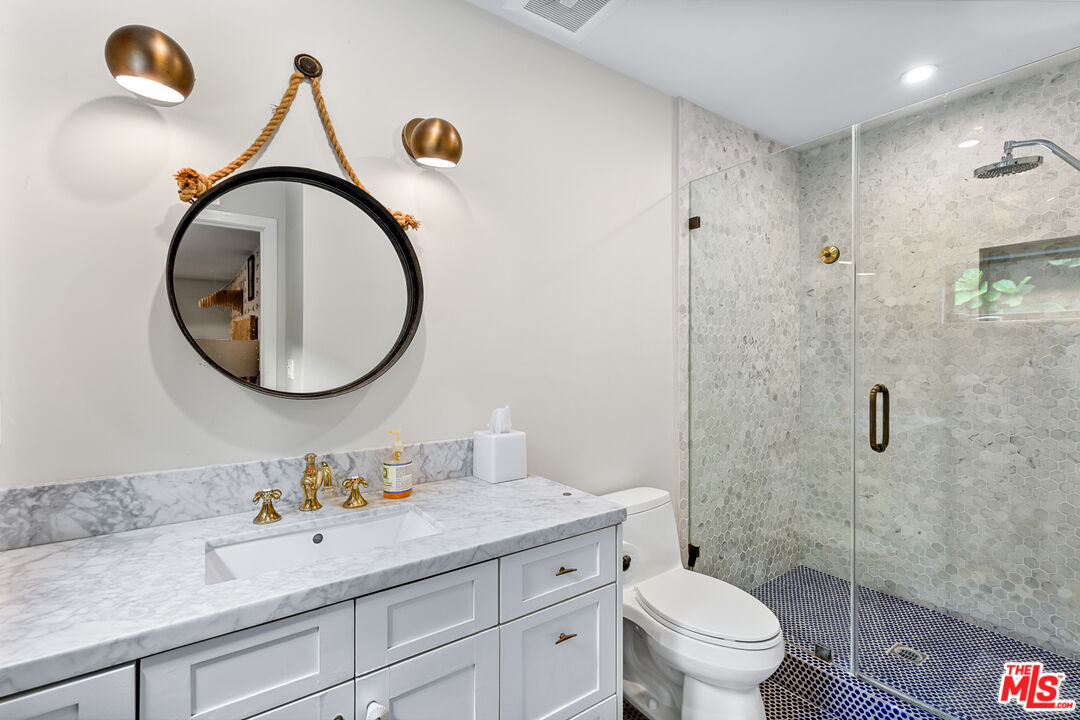 5401 Ostrom Avenue Encino, CA 91316 - Photo 41 of 73 a bathroom with a sink and a mirror