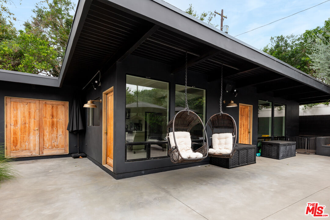 5401 Ostrom Avenue Encino, CA 91316 - Photo 50 of 73 a view of a patio with table and chairs under an umbrella
