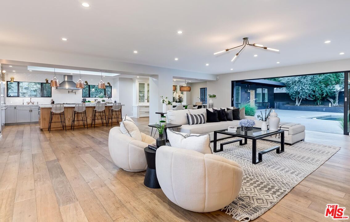 5401 Ostrom Avenue Encino, CA 91316 - Photo 5 of 73 a living room with furniture and a wooden floor