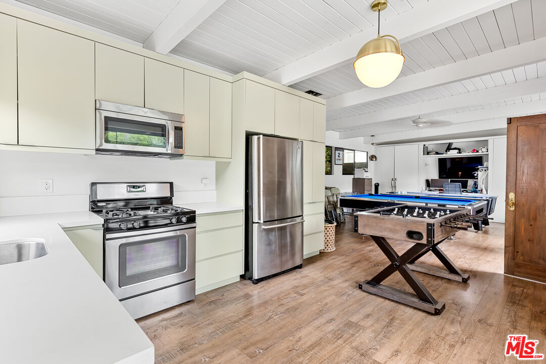 5401 Ostrom Avenue Encino, CA 91316 - Photo 52 of 73 a kitchen with stainless steel appliances granite countertop a stove refrigerator and microwave