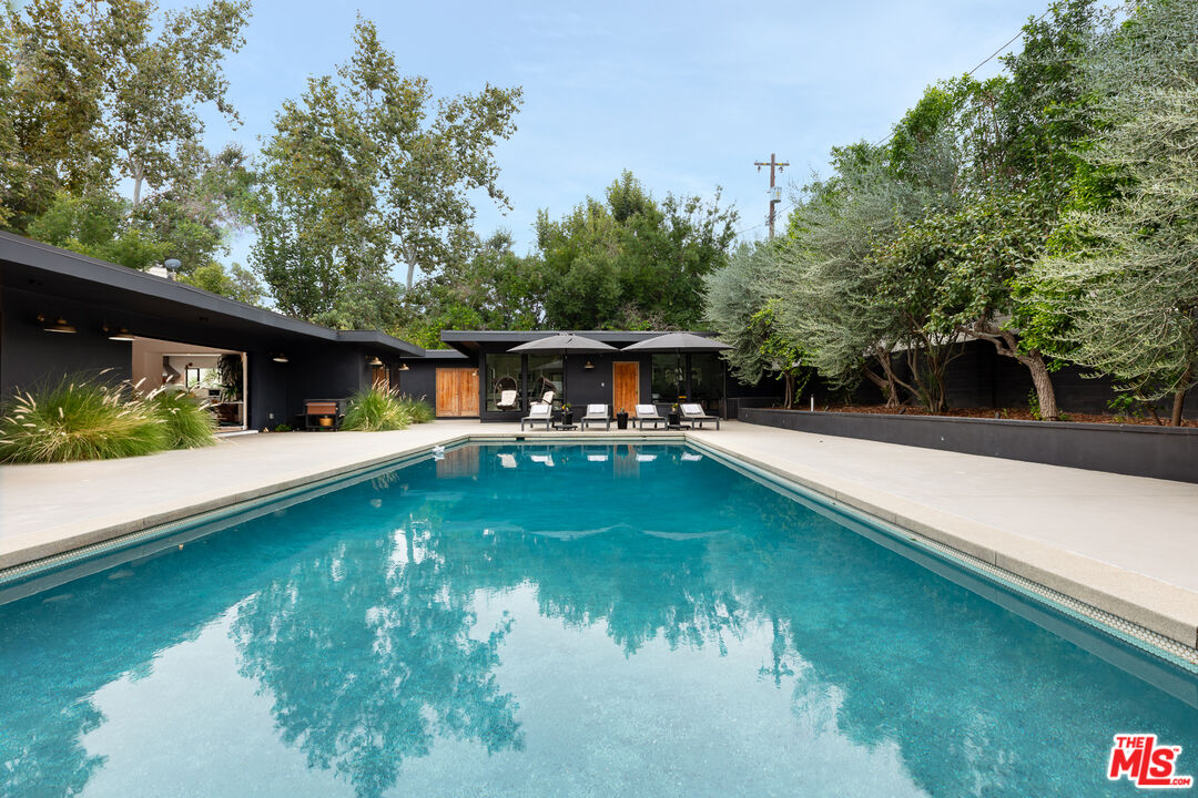 5401 Ostrom Avenue Encino, CA 91316 - Photo 71 of 73 a view of a house with swimming pool next to a yard