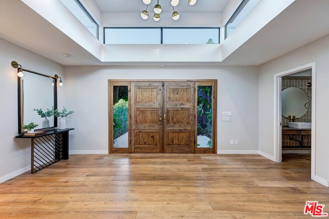 5401 Ostrom Avenue Encino, CA 91316 - Photo 8 of 73 a view of a hallway with wooden floor and windows