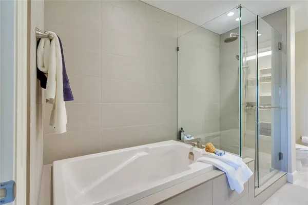 a bathroom with a tub and a shower