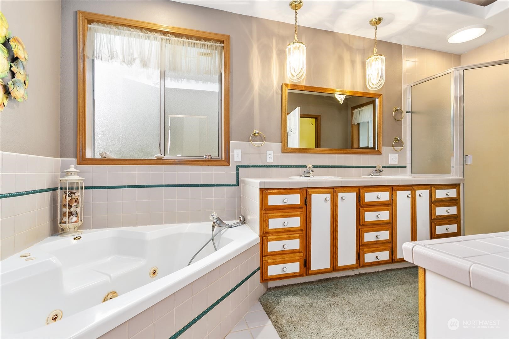 3397 Cedarville Road Bellingham, WA 98226 - Photo 23 of 38 a bathroom with a tub a sink and a large mirror