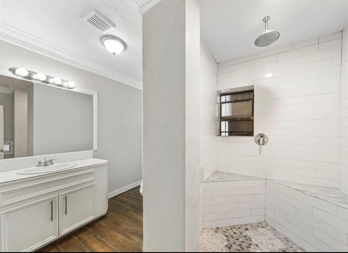1207 Firnat Street Houston, TX 77022 - Photo 13 of 21 a bathroom with a sink and a mirror