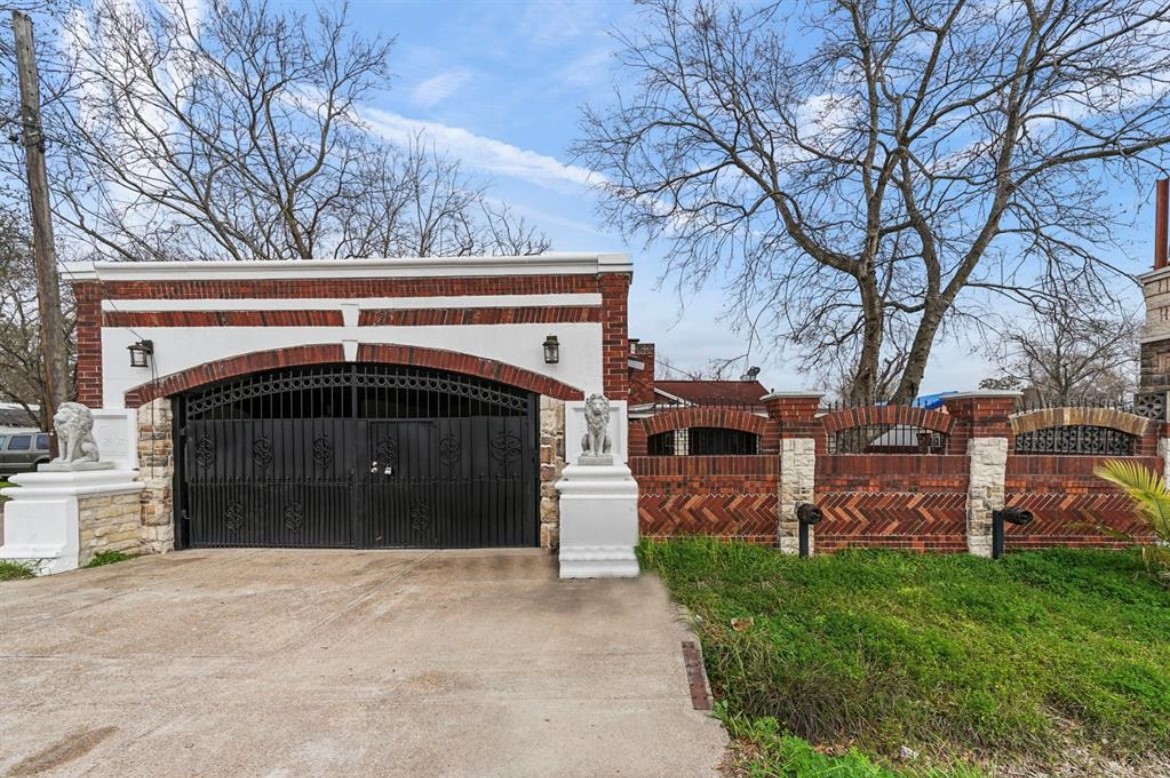 1207 Firnat Street Houston, TX 77022 - Photo 2 of 21 a front view of a house with a yard and garage
