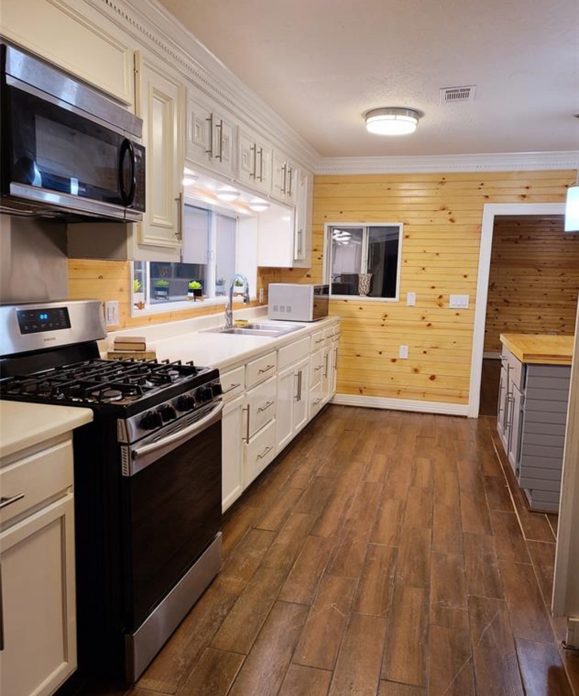 1207 Firnat Street Houston, TX 77022 - Photo 10 of 21 a kitchen with stainless steel appliances a stove sink and microwave