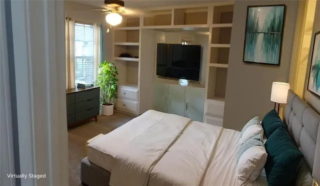 a bedroom with a bed and a television
