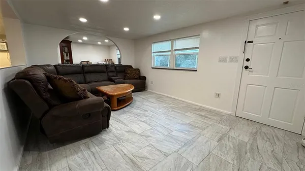 a dining hall with stainless steel appliances furniture and kitchen view