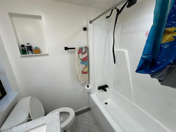 a bathroom with a bathtub and a shower