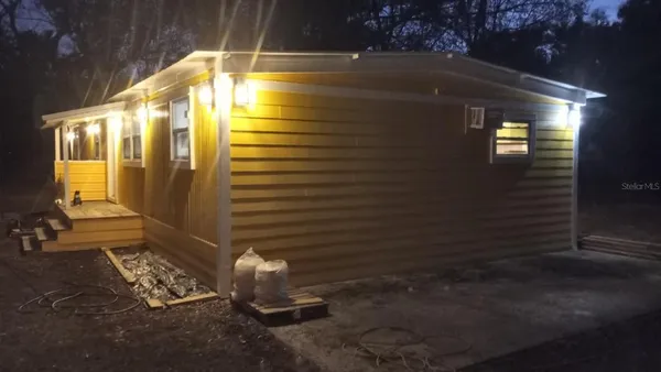 a large kitchen with a table and chairs