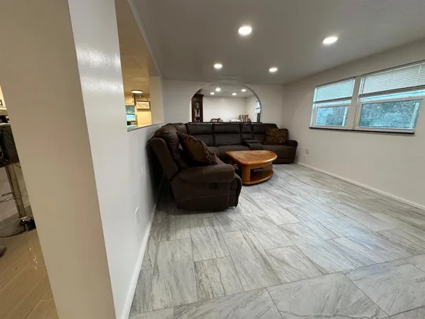 a kitchen with stainless steel appliances granite countertop a sink refrigerator and microwave