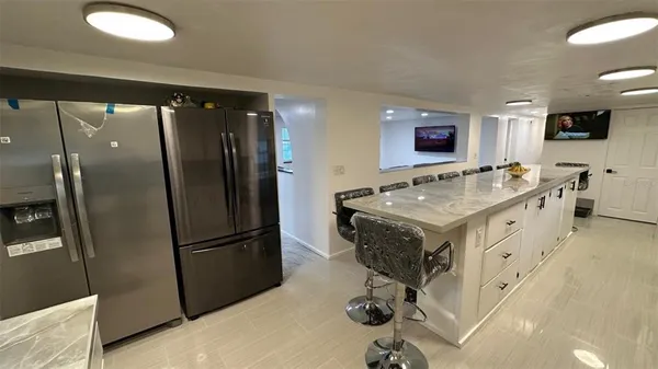 a kitchen with a sink refrigerator and microwave