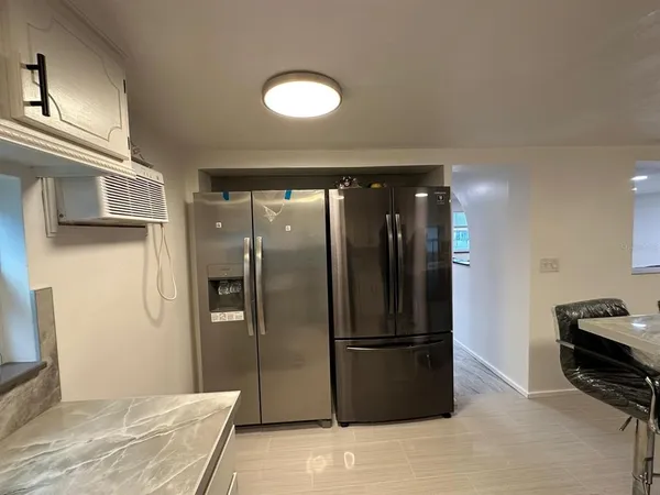 a view of a refrigerator in kitchen and a counter top space