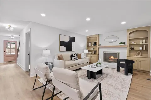 a living room with furniture a fireplace and a table