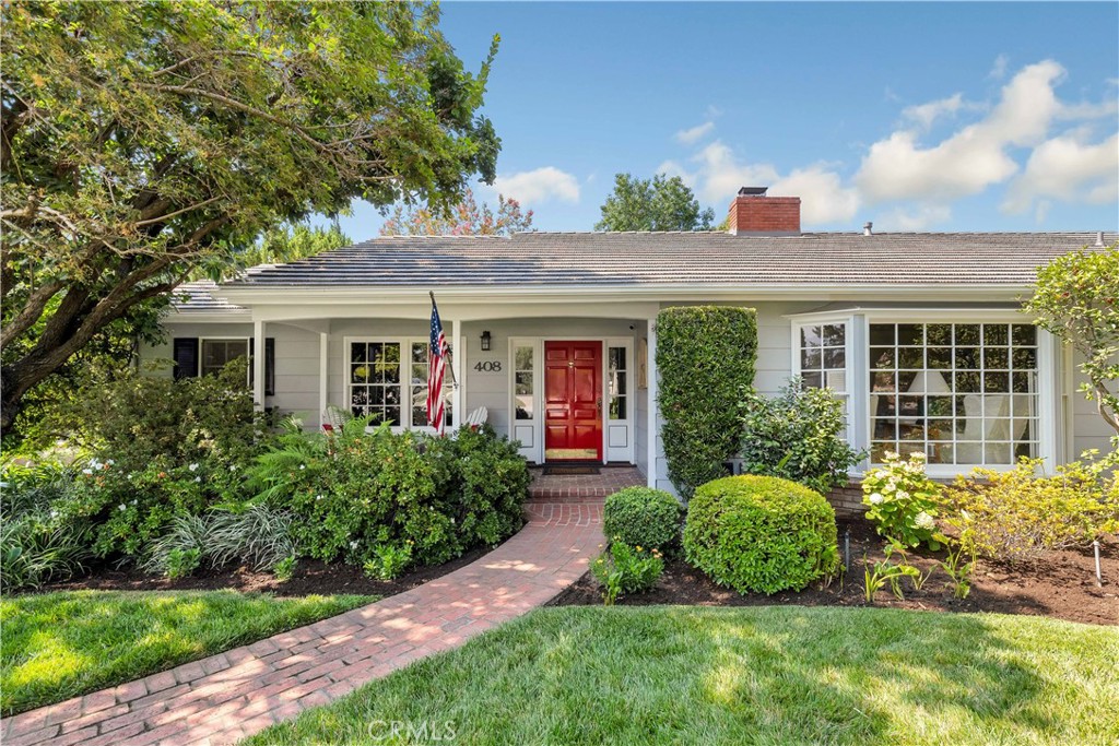 a front view of a house with a yard and outdoor seating