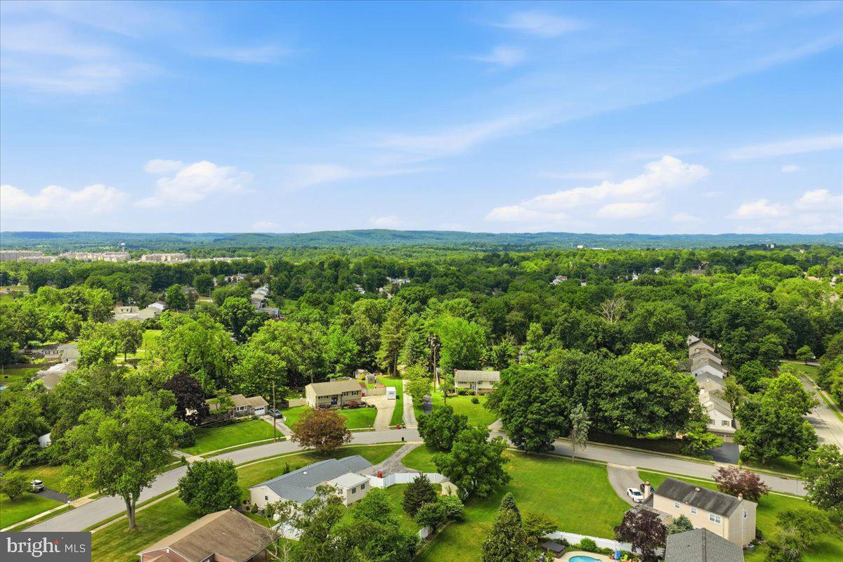 148 Regency Drive Eagleville, PA 19403 - Photo 42 of 42 Lush green neighborhood under blue skies.