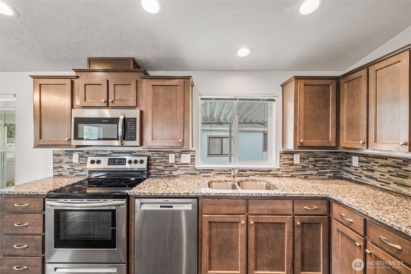 2101 South 324th Street, Unit 14 Federal Way, WA 98003 - Photo 15 of 38 a kitchen with stainless steel appliances granite countertop a sink stove and cabinets