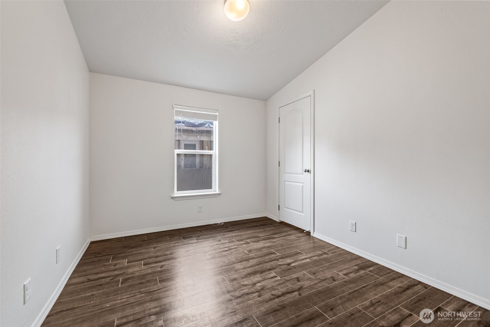 2101 South 324th Street, Unit 14 Federal Way, WA 98003 - Photo 23 of 38 an empty room with wooden floor and windows
