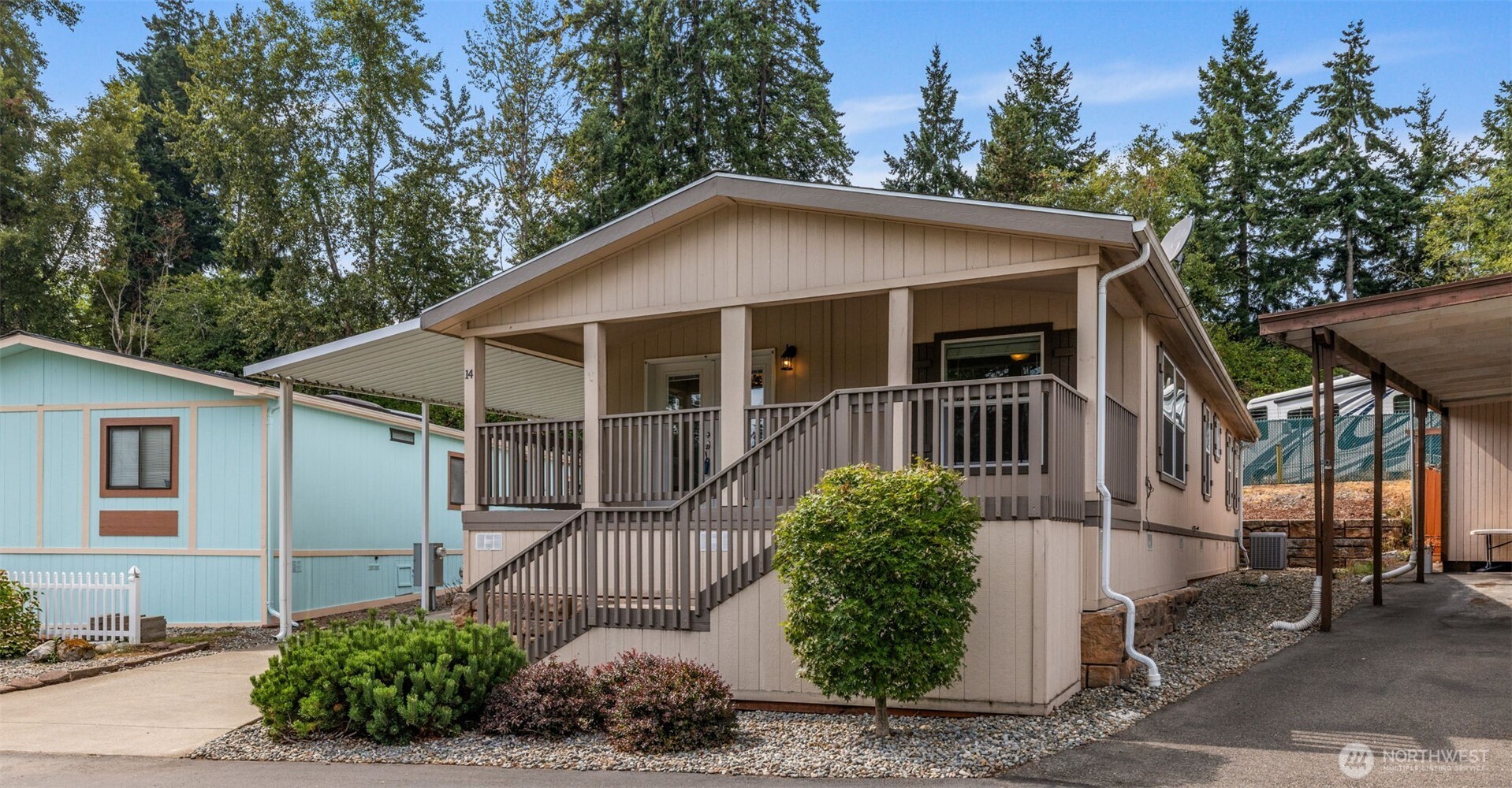 2101 South 324th Street, Unit 14 Federal Way, WA 98003 - Photo 3 of 38 a view of a small house with a small yard plants and large tree
