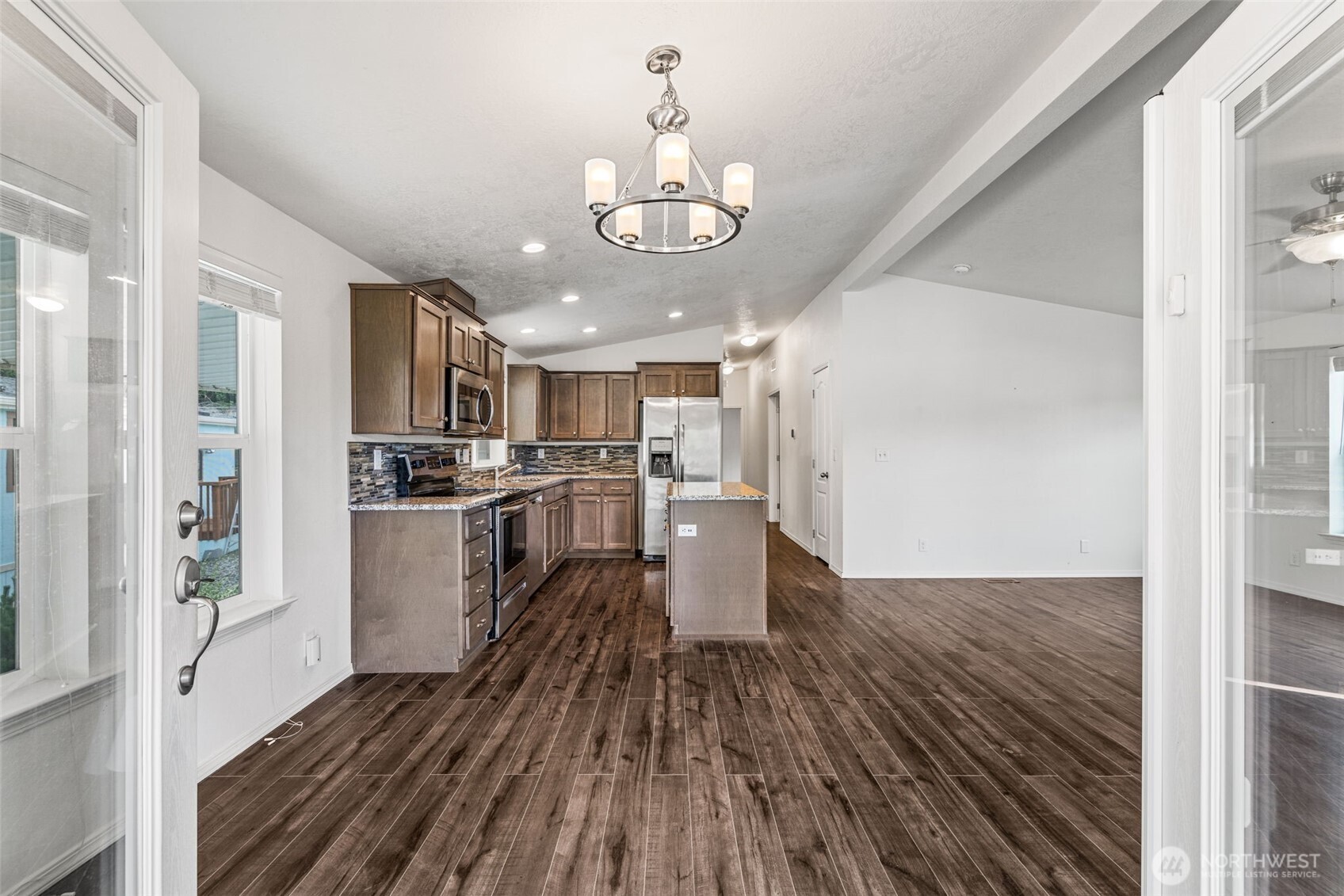 2101 South 324th Street, Unit 14 Federal Way, WA 98003 - Photo 6 of 38 a kitchen with wooden floors and refrigerator