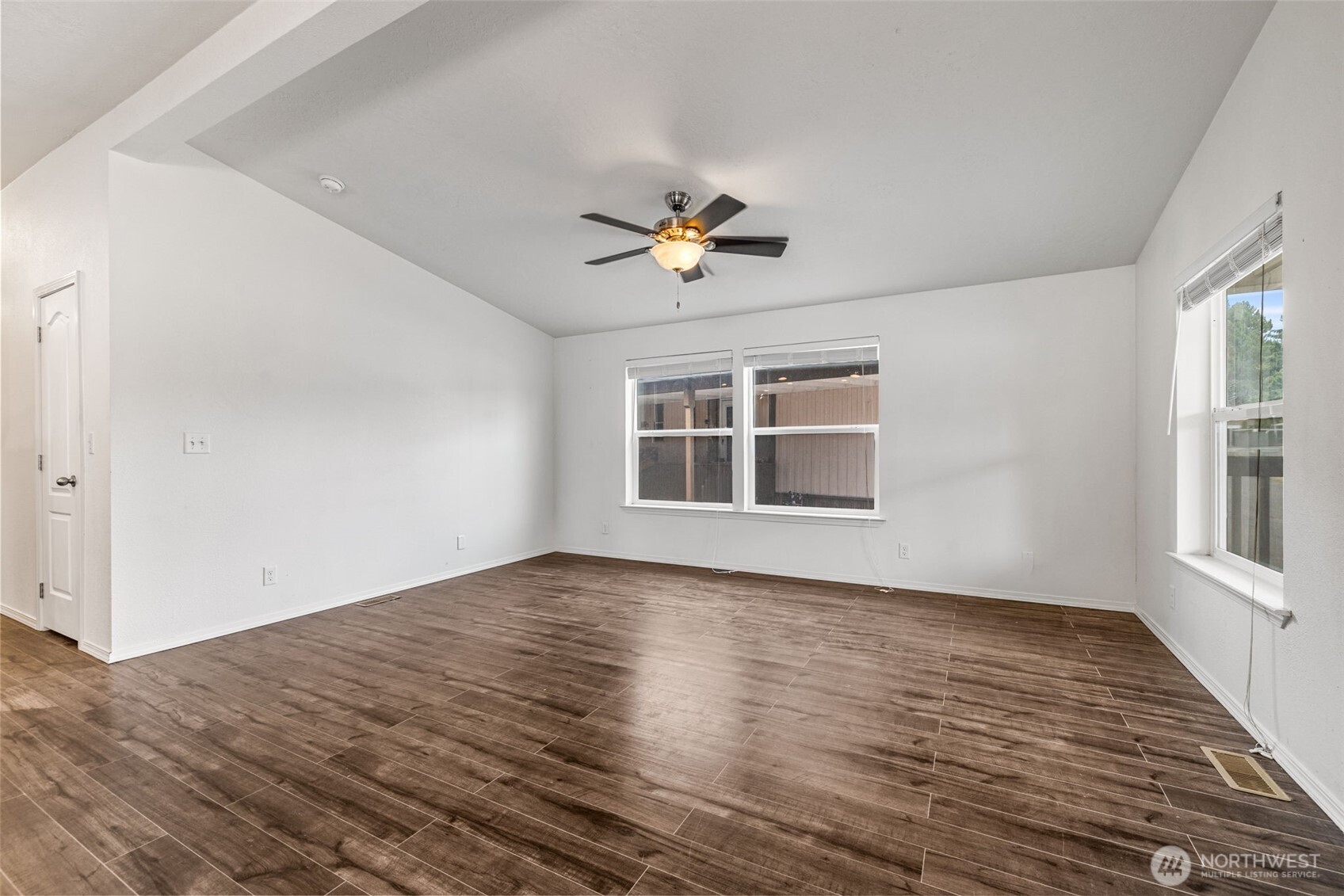 2101 South 324th Street, Unit 14 Federal Way, WA 98003 - Photo 9 of 38 a view of empty room with wooden floor and fan