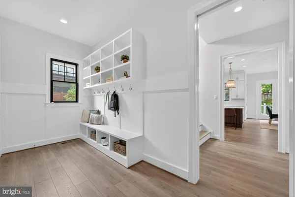 a living room with furniture wooden floor and a large window