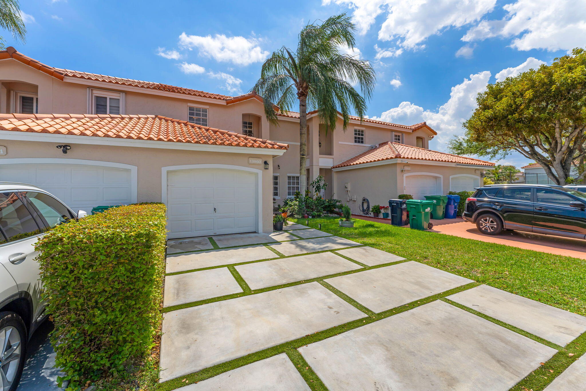13860 Southwest 102nd Terrace Miami, FL 33186 - Photo 2 of 39 a view of a white house with a yard and potted plants