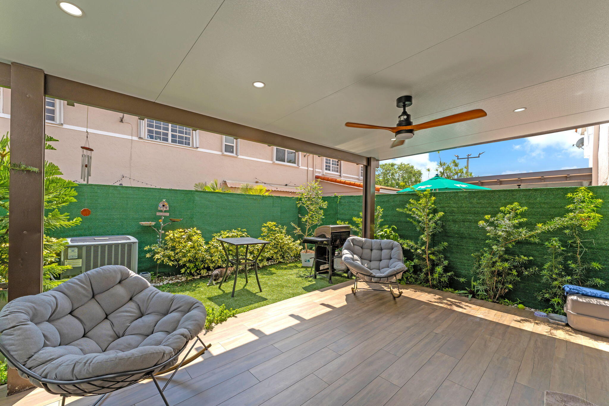 13860 Southwest 102nd Terrace Miami, FL 33186 - Photo 27 of 39 a outdoor living space with furniture potted plant and a floor to ceiling window