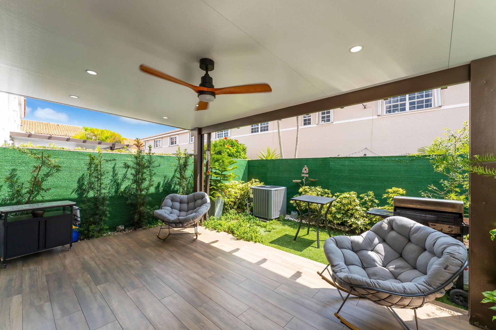 13860 Southwest 102nd Terrace Miami, FL 33186 - Photo 28 of 39 a living room with patio furniture and a garden