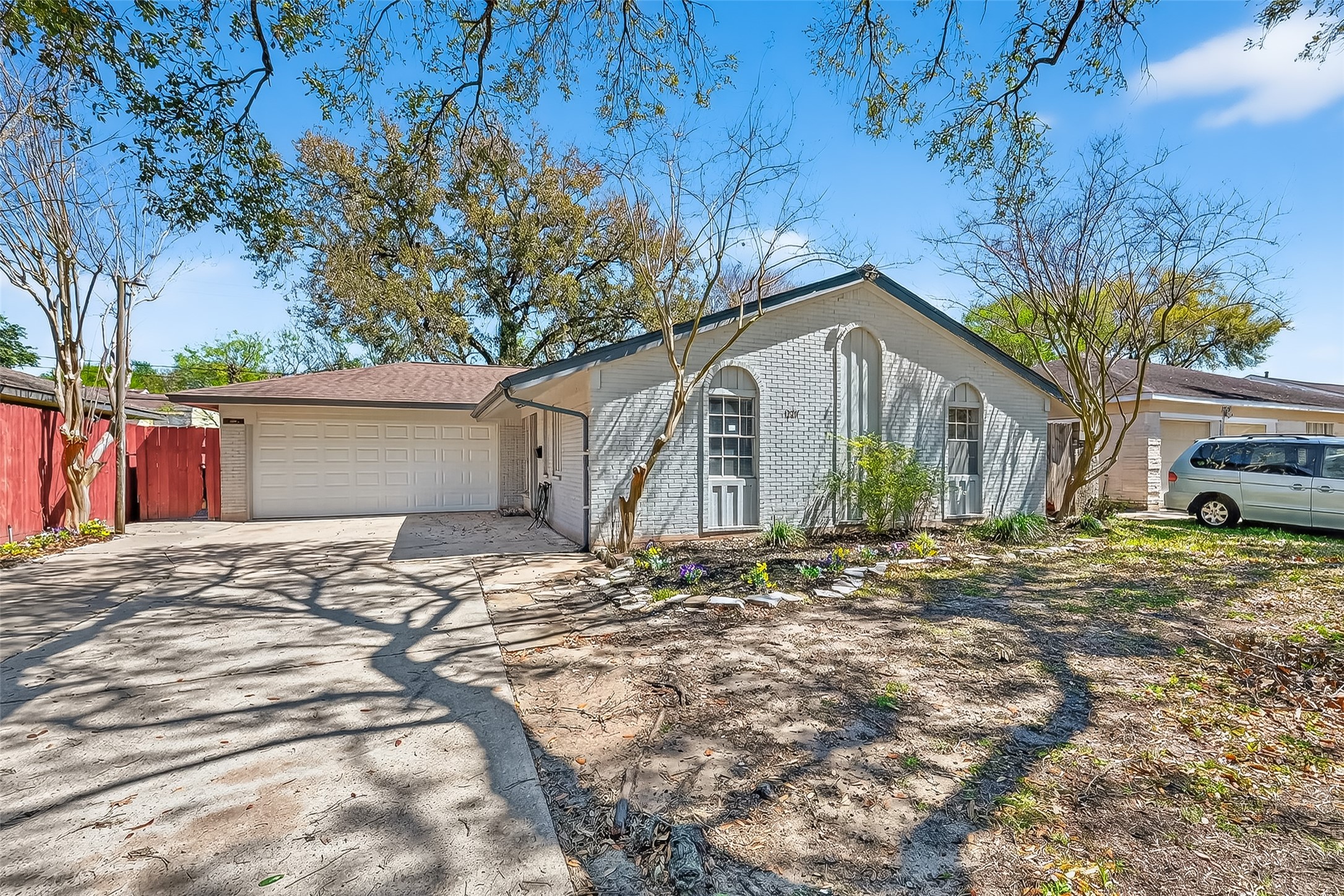 12211 Chimney Rock Road Houston, TX 77035 - Photo 1 of 27 a front view of a house with a yard and garage