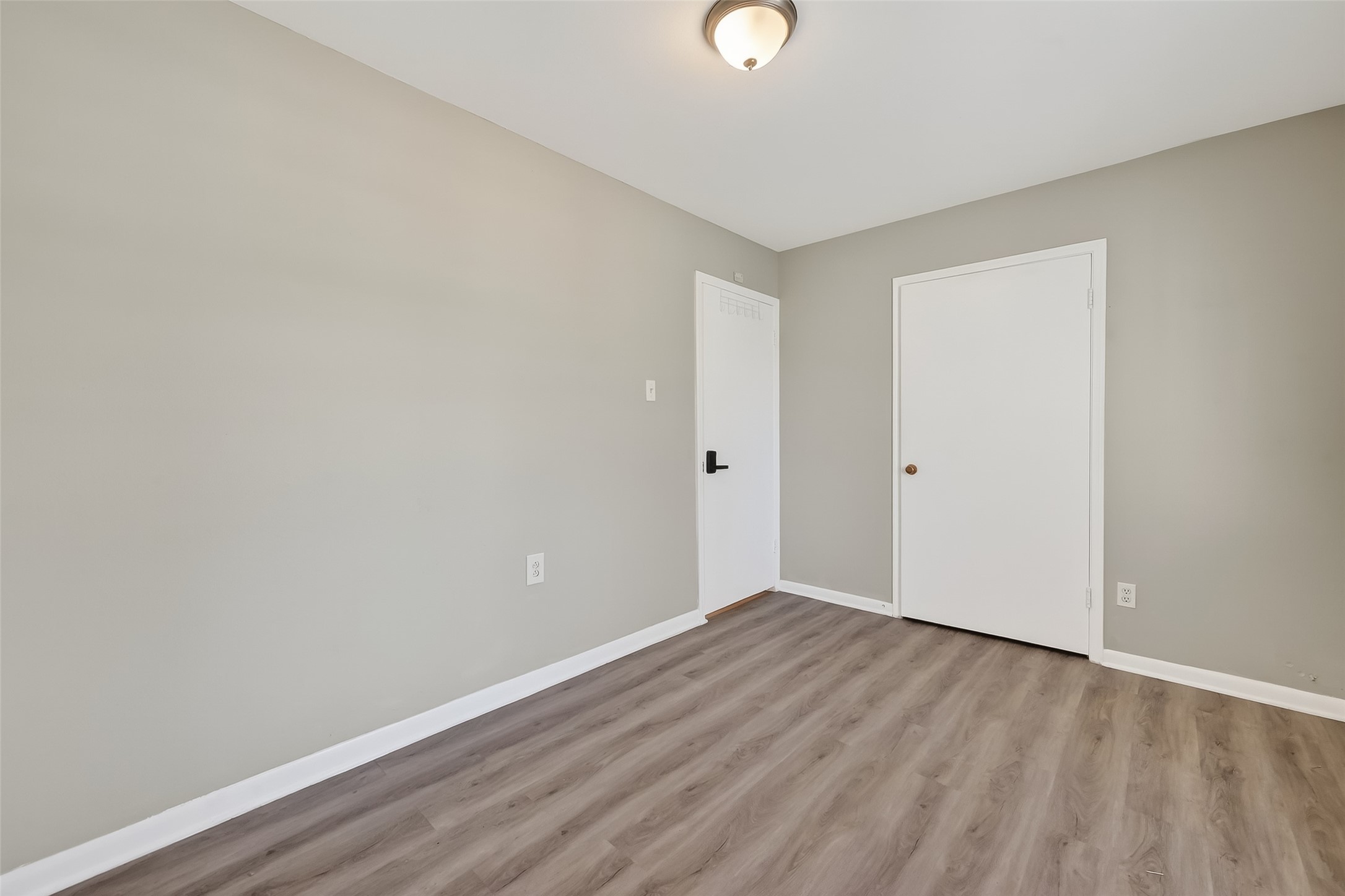 12211 Chimney Rock Road Houston, TX 77035 - Photo 16 of 27 a view of an empty room with wooden floor
