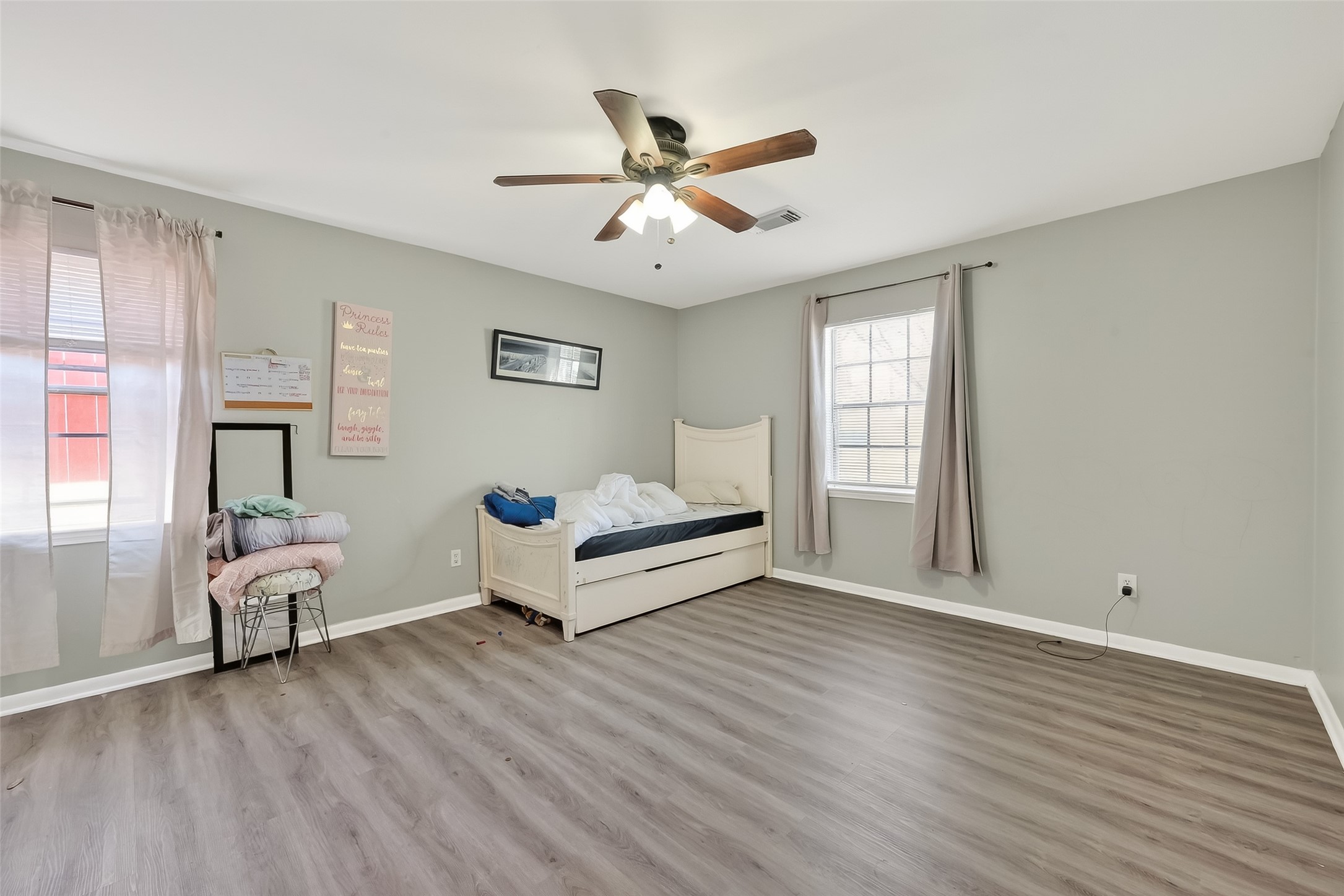 12211 Chimney Rock Road Houston, TX 77035 - Photo 18 of 27 an empty room with wooden floor and windows