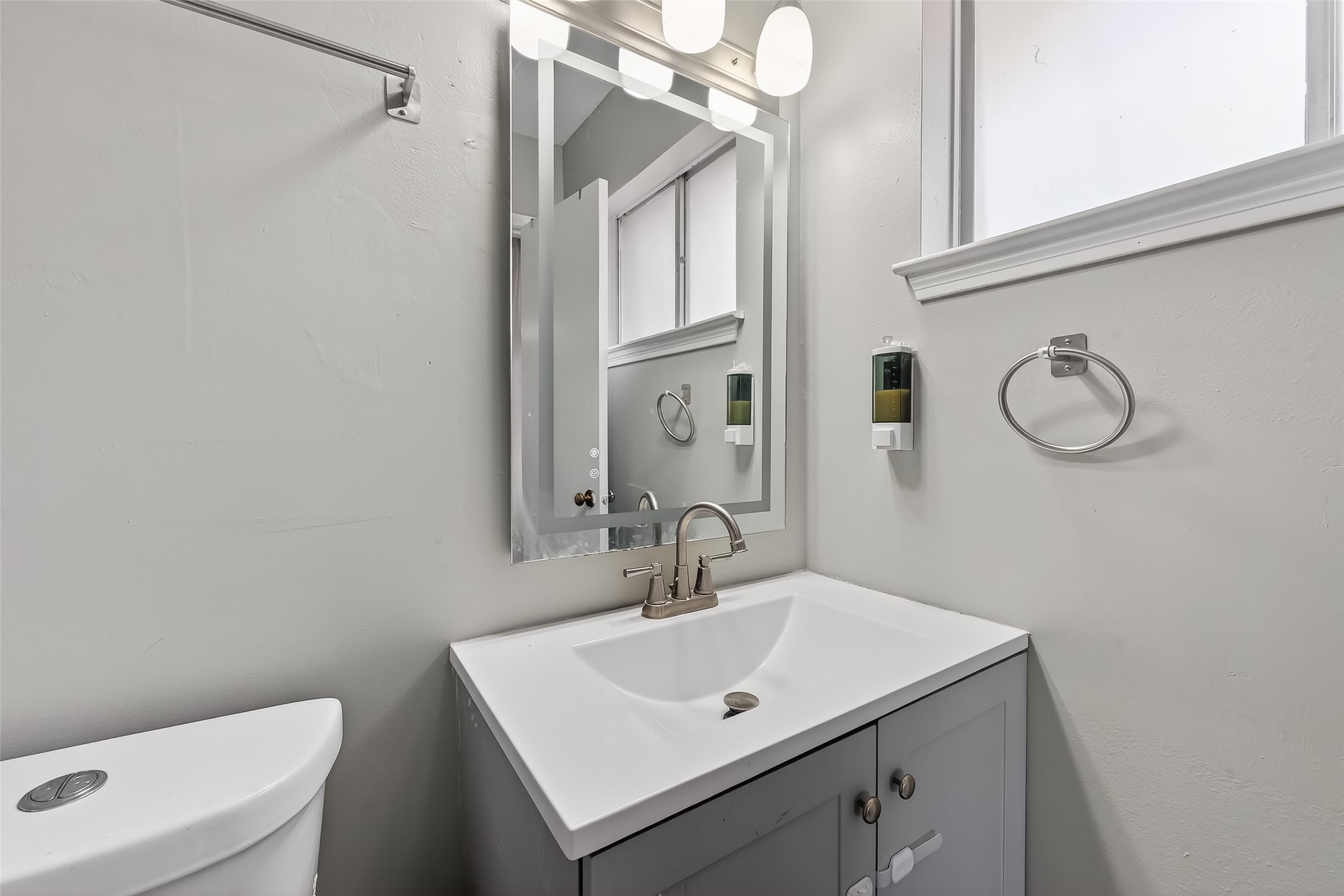 12211 Chimney Rock Road Houston, TX 77035 - Photo 20 of 27 a bathroom with a sink a toilet and a mirror
