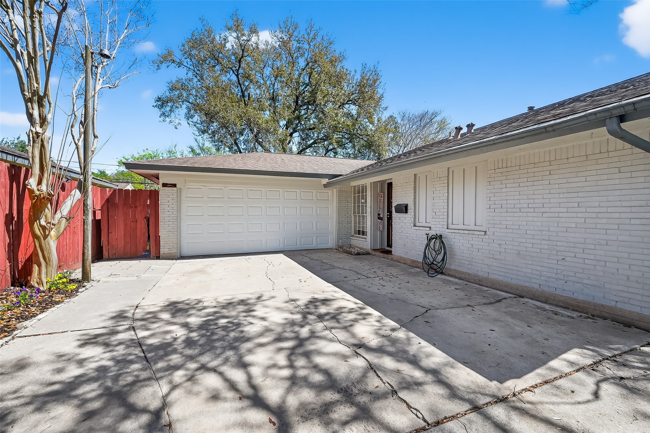 12211 Chimney Rock Road Houston, TX 77035 - Photo 27 of 27 a front view of a house with a yard and garage