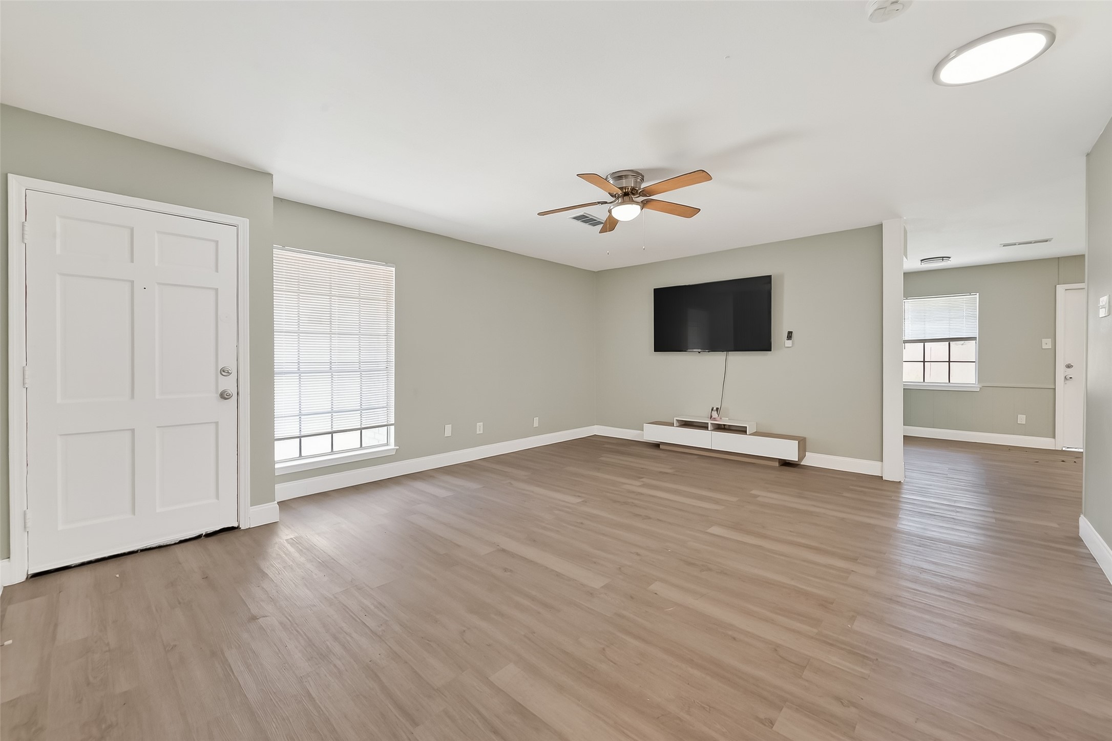 12211 Chimney Rock Road Houston, TX 77035 - Photo 3 of 27 an empty room with wooden floor and windows