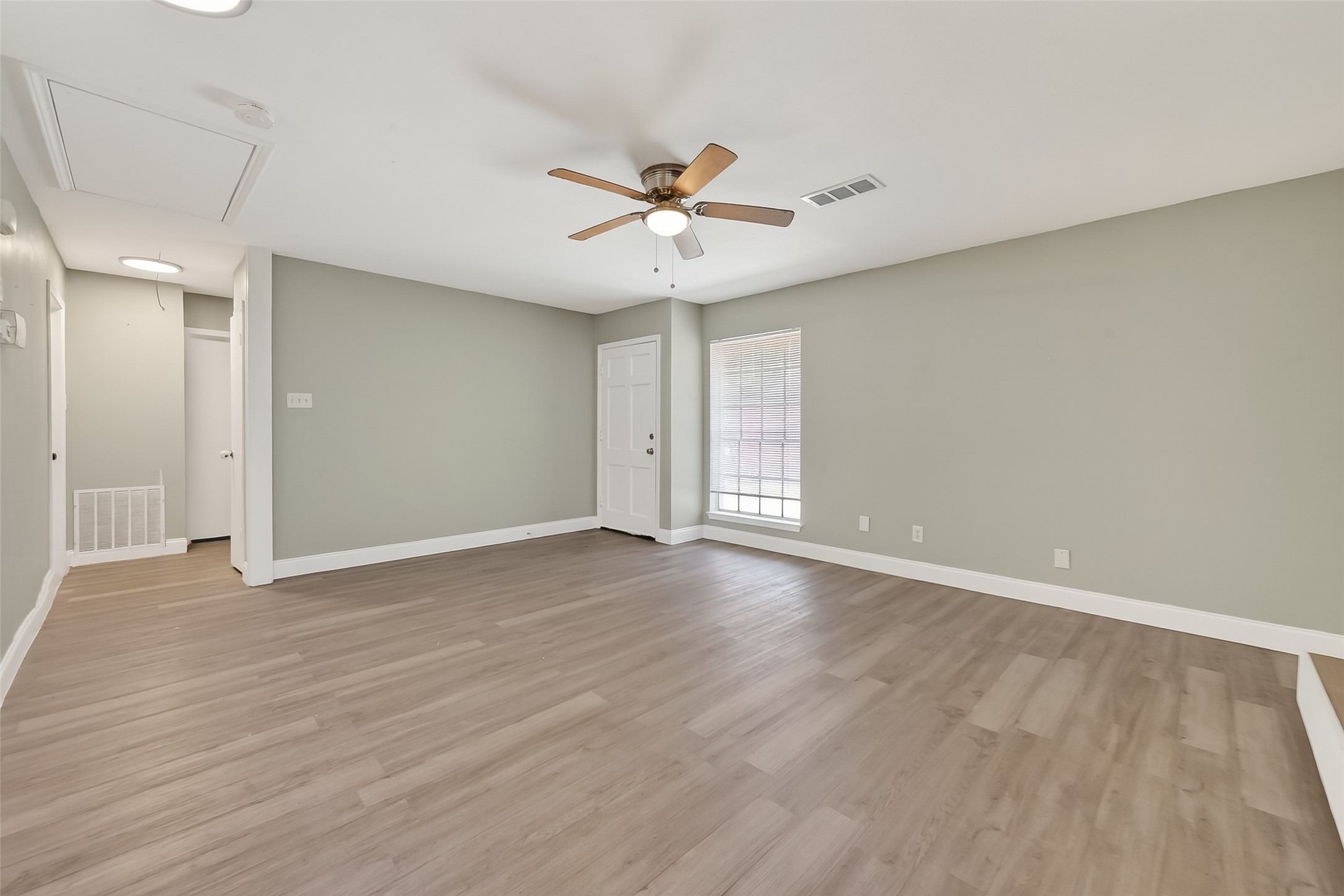 12211 Chimney Rock Road Houston, TX 77035 - Photo 4 of 27 wooden floor in an empty room with a window