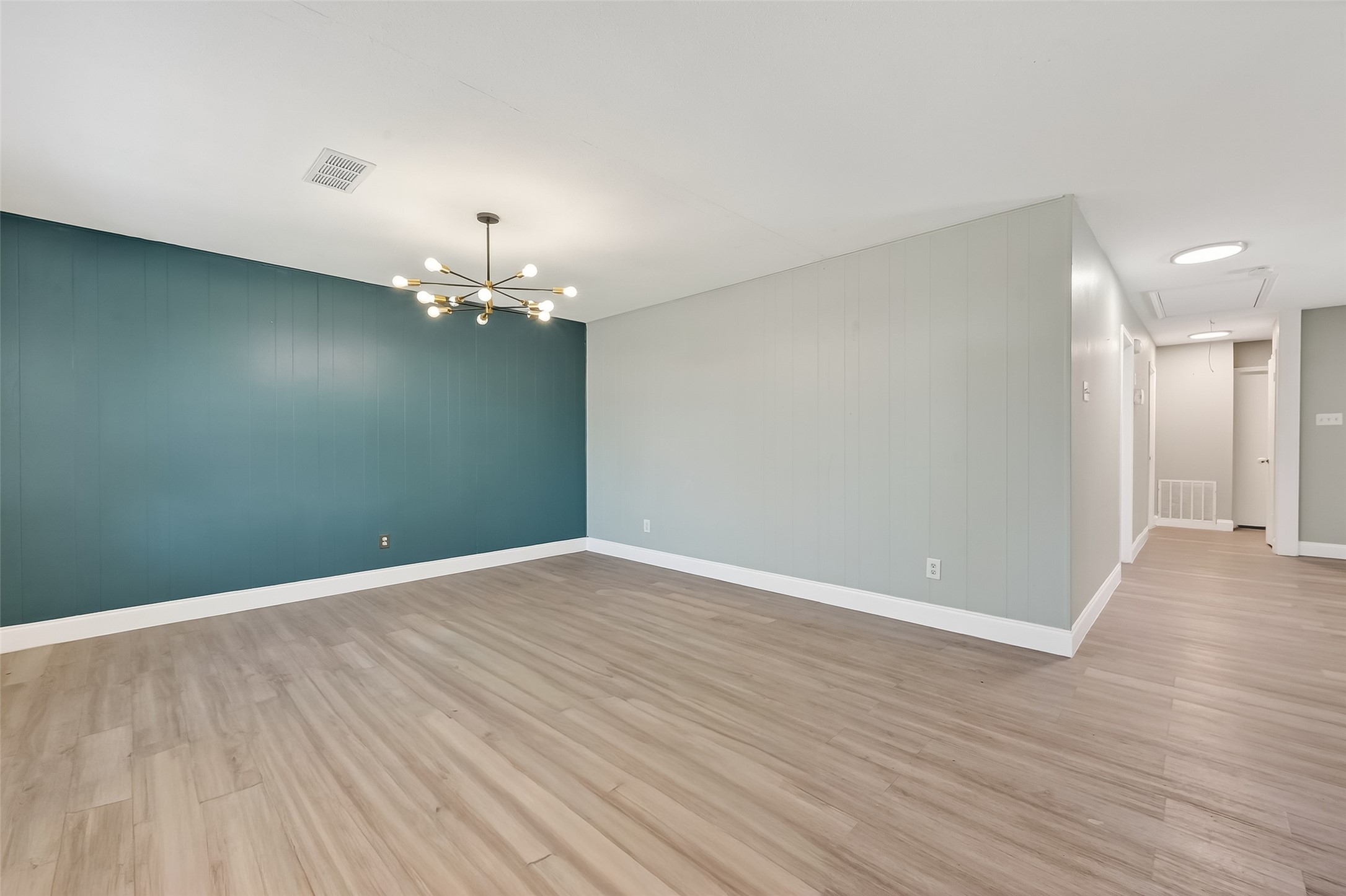12211 Chimney Rock Road Houston, TX 77035 - Photo 6 of 27 a view of a room with wooden floor and chandelier