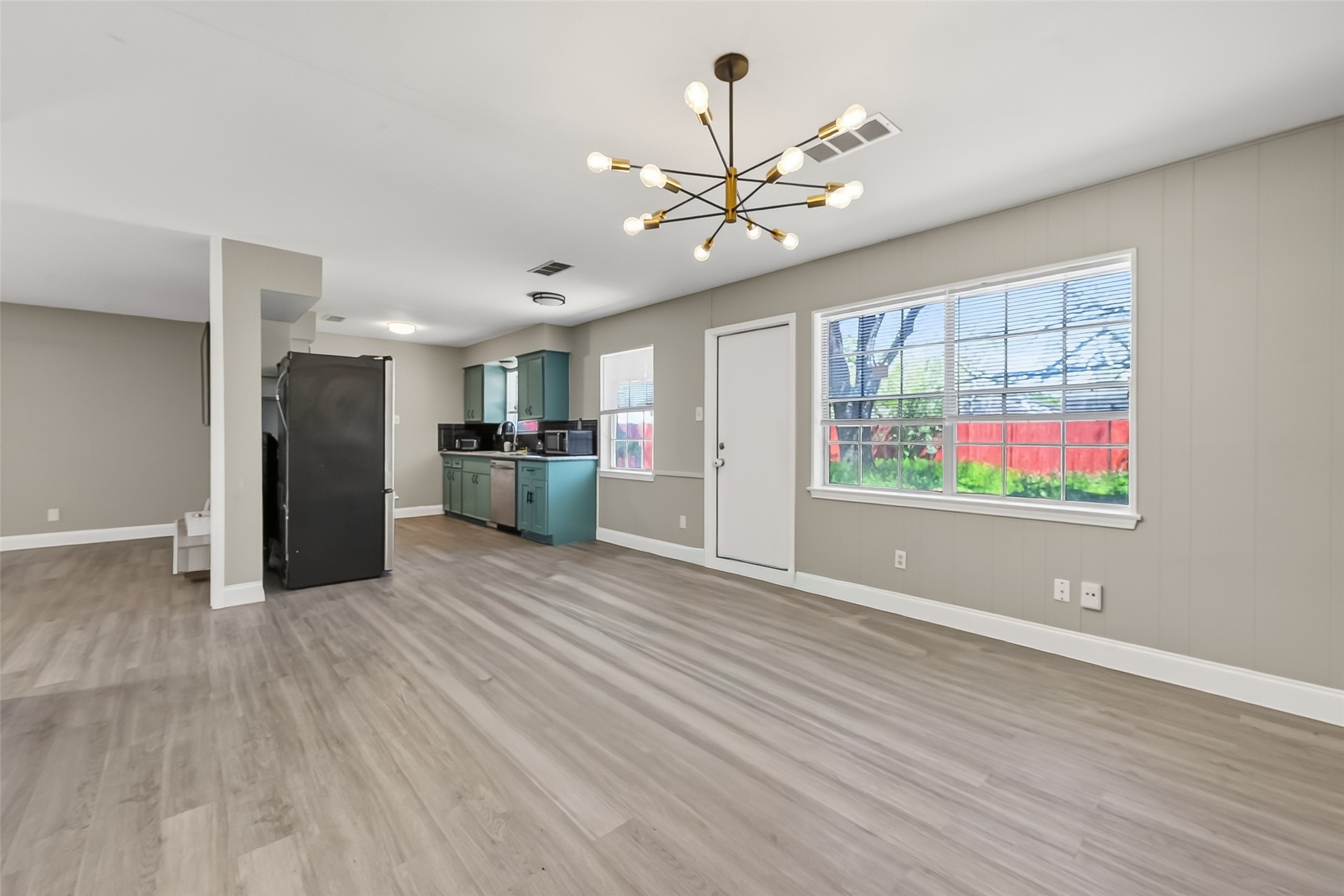 12211 Chimney Rock Road Houston, TX 77035 - Photo 7 of 27 a view of an empty room with window and wooden floor