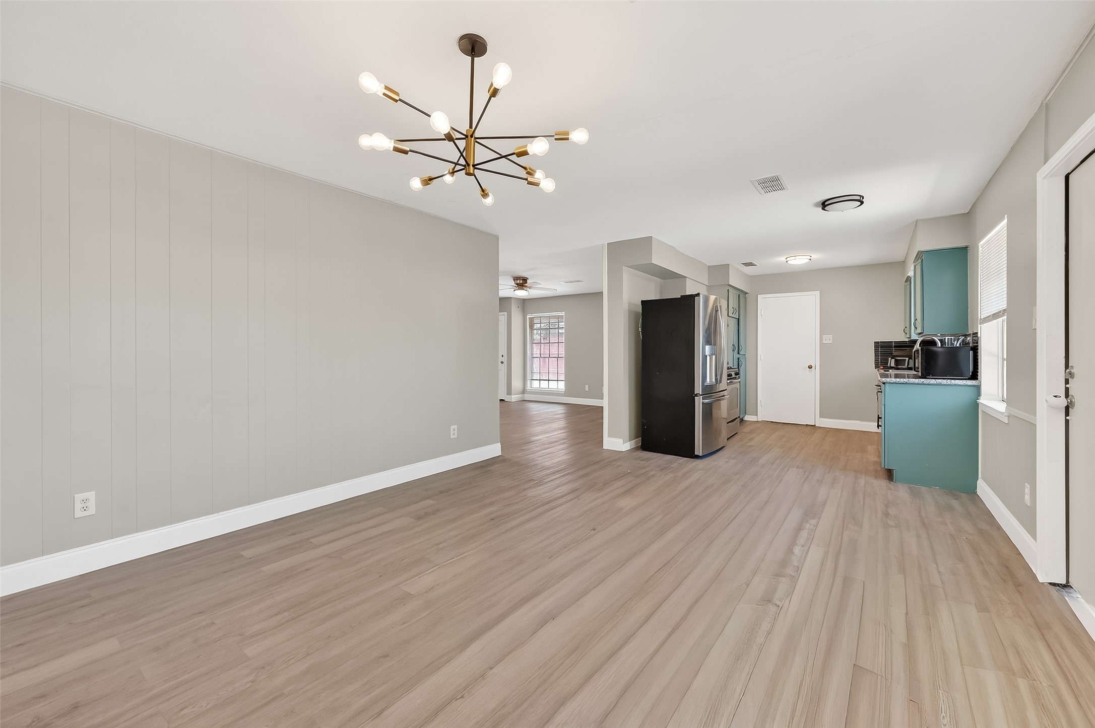 12211 Chimney Rock Road Houston, TX 77035 - Photo 8 of 27 a view of a livingroom with a chandelier fan and wooden floor
