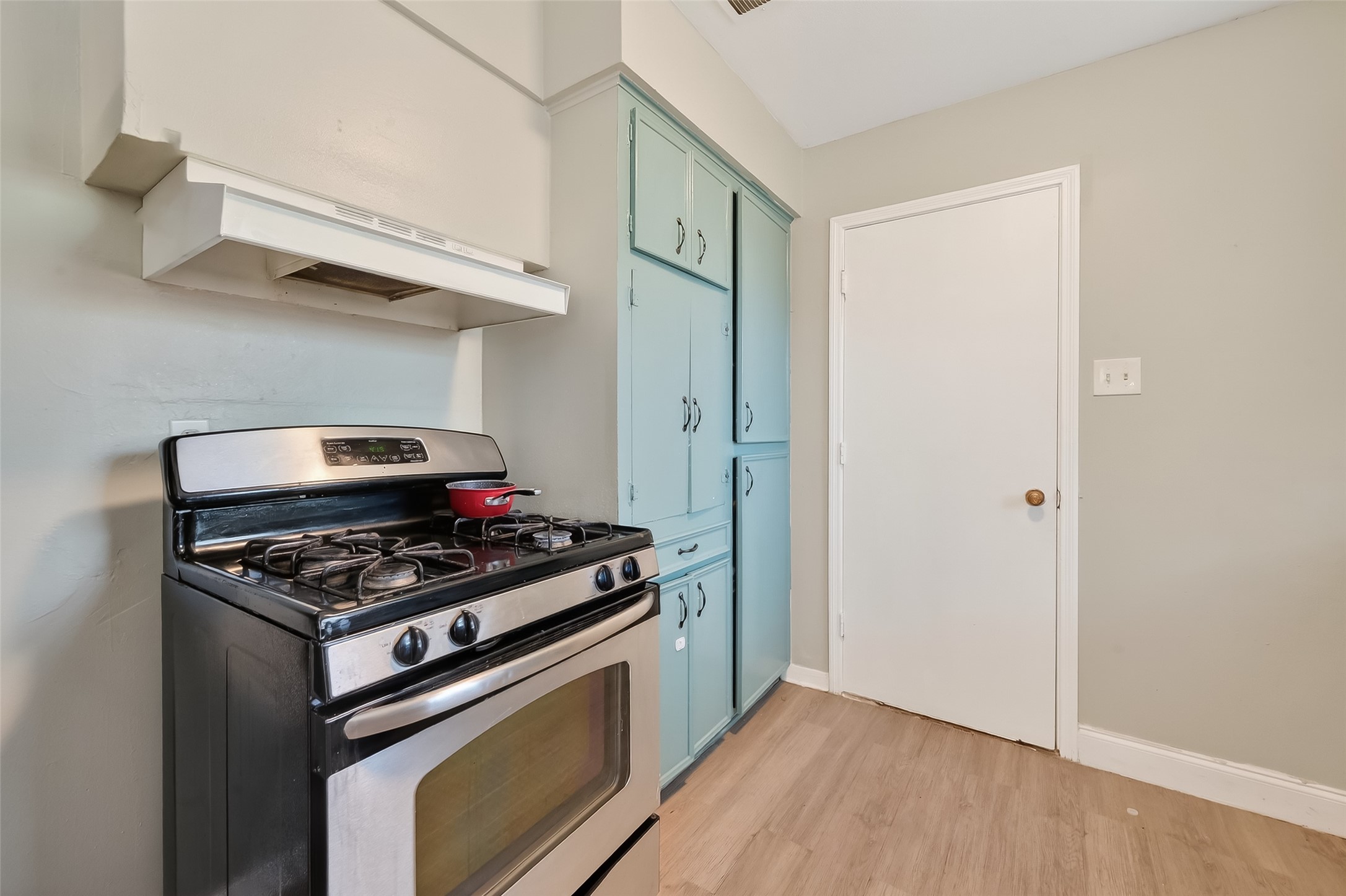 12211 Chimney Rock Road Houston, TX 77035 - Photo 10 of 27 a kitchen with wooden floor and a stove top oven